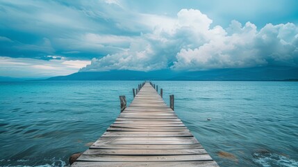 A wooden pier that stretches out to the sea,seascape view with Mountain and cloudy sky for travel in holiday relax time as summer --ar 16:9 --v 6 Job ID: bbb6760d-17d8-40fe-a6de-947e00b6b410 - obrazy, fototapety, plakaty