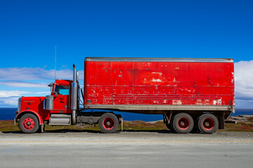 truck with a red color and a trailer shape and a freight overlay on the side