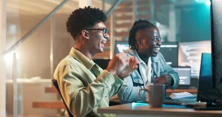 Success, teamwork or software development in office for connection or collaboration on coding on laptop. Men, happy or fist pump for celebration in programming, neon or futuristic technology at night - Powered by Adobe