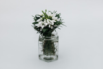 a bouquet of spring flowers in a vase on a white background