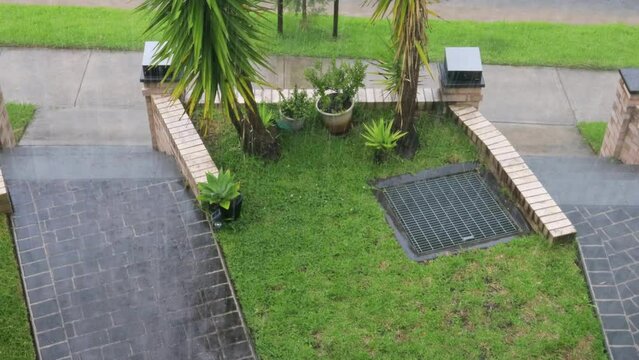 Hailstorm falling hail stones on front yard of residential house in Sydney as 4k.
