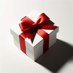 Obraz premium Caja de regalo blanca con lazo de cinta roja, aislada sobre fondo blanco