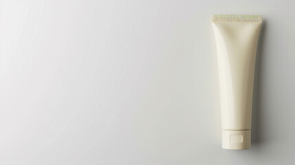 A simplistic round hand cream tube, empty and showcased against a white backdrop with ample space.