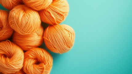 Soft orange wool skeins displayed on a turquoise background, creating an appealing play of pastel...