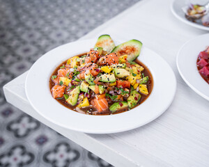 Mexican style salmon ceviche, with pineapple, avocado, onion, cucumber, cilantro and sauces, tropical style, fresh mexican seafood, for mexican tuna tostadas