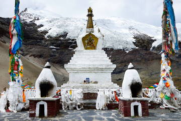 A Buddhist stupa sits in front of the Karo-La Glacier on Karo-La Pass in the Himalayan mountains of Tibet Autonomous Region. - Powered by Adobe