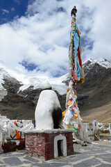 At an altitude of over 16,000' on Karo-La Pass in the Himalayan mountains, sits a Buddhist stupa in front of the Karo-La Glacier.