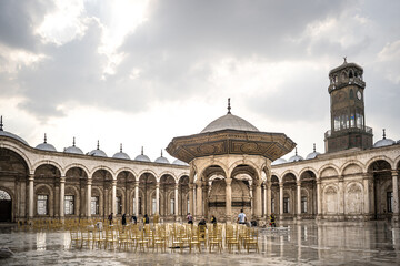 Cairo, Egypt - October 25, 2022. View of the courtyard (sahn) and the clock tower in the Mosque of Muhammad Ali in the Citadel of Cairo.