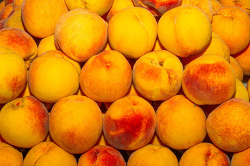 High energy antioxidant food, health booster juicy peaches super fruit on sale at local fruit market. Nutrition healthcare concept.