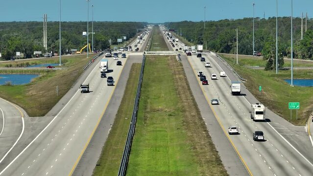Aerial view of american freeway with many driving cars during rush hour in Sarasota county, Florida. Rising heat gives a shimmering mirage effect over the pavement
