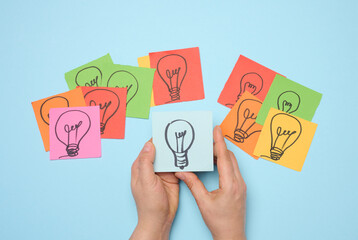 Drawn electric lamps on stickers, concept of searching for new ideas, brainstorming