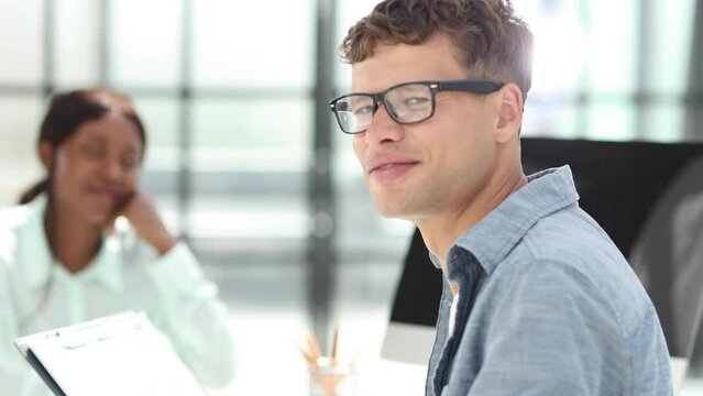 Group of business persons talking in the office.