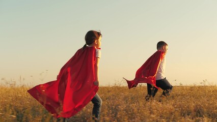 happy dream little superheroes winners, happy children running red cloaks sunset, children fantasy...