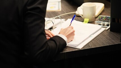 Police agent using landline phone, answering call and taking notes to evaluate evidence...