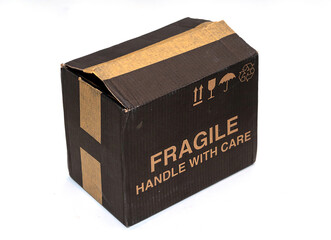 Closed cardboard transport box with fragile sign written outside on white background