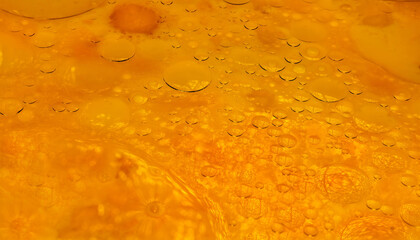 Textured orange color food background. Batter for pancakes. Drops of vegetable oil on surface of pancake batter
