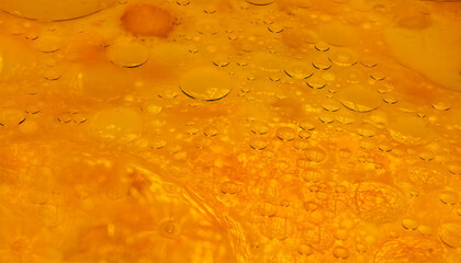 Textured orange color food background. Batter for pancakes. Drops of vegetable oil on surface of pancake batter