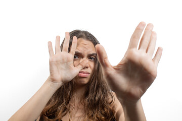Portrait of a young blonde Latin American woman, expression of rejection with her hands in front of her face