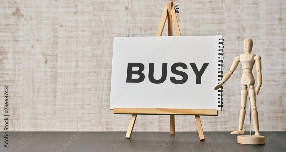 Poster there is notebook with the word busy. it is as an eye-catching image.