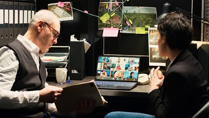 Detectives attending online videocall with witnesses, asking questions about crime scene and criminal activity. Law agents taking statements on remote telework meeting. Handheld shot.