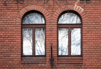 Glare and windows, reflections on the facade of an old tenement house, old town, Gniezno, Poland.