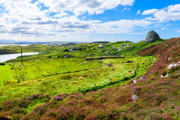 The ancient hilltop ruins of the Dun Carloway Broch roundhouse on a sunny summer day in the district of Carloway, Isle of Lewis, Scotland, United Kingdom.	