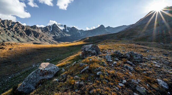 Autumnal high valley in atmospheric light, Keldike Valley on the way to the Ala Kul Pass, Sun Star, Tien Shan Mountains, Kyrgyzstan, Asia