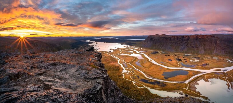 View from Skierffe mountain over the autumnal Rapadalen river delta, sunrise, Rapaaelv river, Sarek National Park, Laponia, Lapland, Sweden, Europe