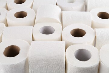 Many soft toilet paper rolls as background, closeup