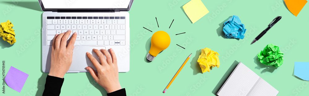 Poster laptop computer with a light bulb from above