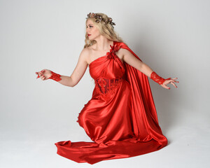 Full length portrait of beautiful blonde model dressed as ancient mythological fantasy goddess in...