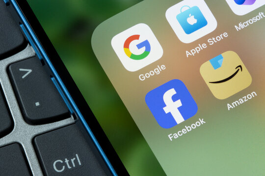 Portland, OR, USA - Feb 14, 2024: App icons representing Google, Apple, Microsoft, Meta, and Amazon are seen on an iPhone. Big tech concept.