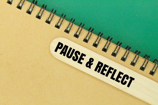 book and ice cream stick with the words pause and reflect