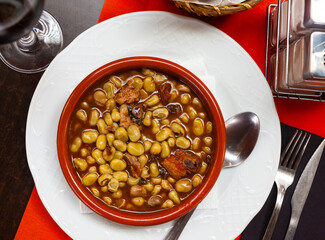 Popular Catalan style beans cooked with sliced blood sausage, chorizo, fried bacon and spices..