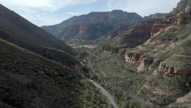 Highway 89A in Sedona, Arizona with mountains and cars driving with drone video wide shot stable.