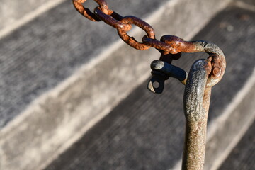Rusted chain used as fence.