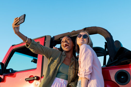 Diverse friends take a selfie in a car on a road trip