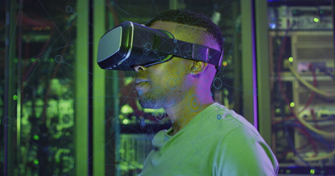 Image of data processing, african american male it engineer in vr goggles and computer servers - Powered by Adobe