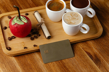 the bank card is on the table in the coffee shop next to the cof