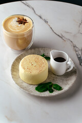mousse dessert on a plate and coffee in a coffee shop on the tab