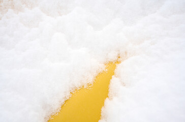 Heavy snow deposited on yellow pipe
