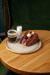 coffee in a glass cup and dessert on the table in the coffee sho