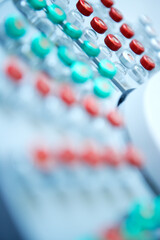 A close-up of vials with red and green caps