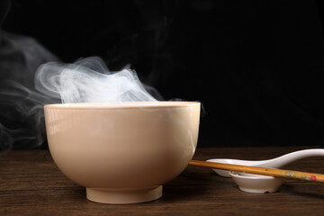 Smoke vape fog rising flowing out of miso soup black red white bowl on dark black background - 736743071