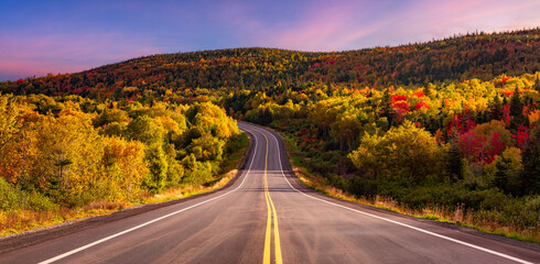 Scenic Road in Canadian Mountain Landscape Fall Season. Sunrise sky. Newfoundland, Canada.