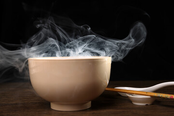 Smoke vape fog rising flowing out of miso soup black red white bowl on dark black background - 736743215