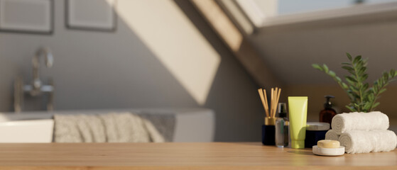 A display space on a hardwood table with bath accessories in a modern bright and clean bathroom.