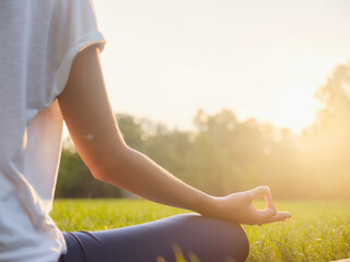 Young asian woman doing meditation in morning or evening at park, healthy woman relaxing and...