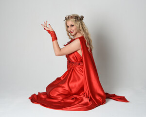 Full length portrait of beautiful blonde model dressed as ancient mythological fantasy goddess in...