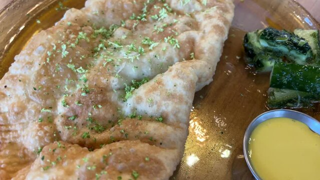 Housewife roasts chebureks Georgian national dish.cook prepares meat pies, working with the dough and filling, close-up. High quality 4k footage
